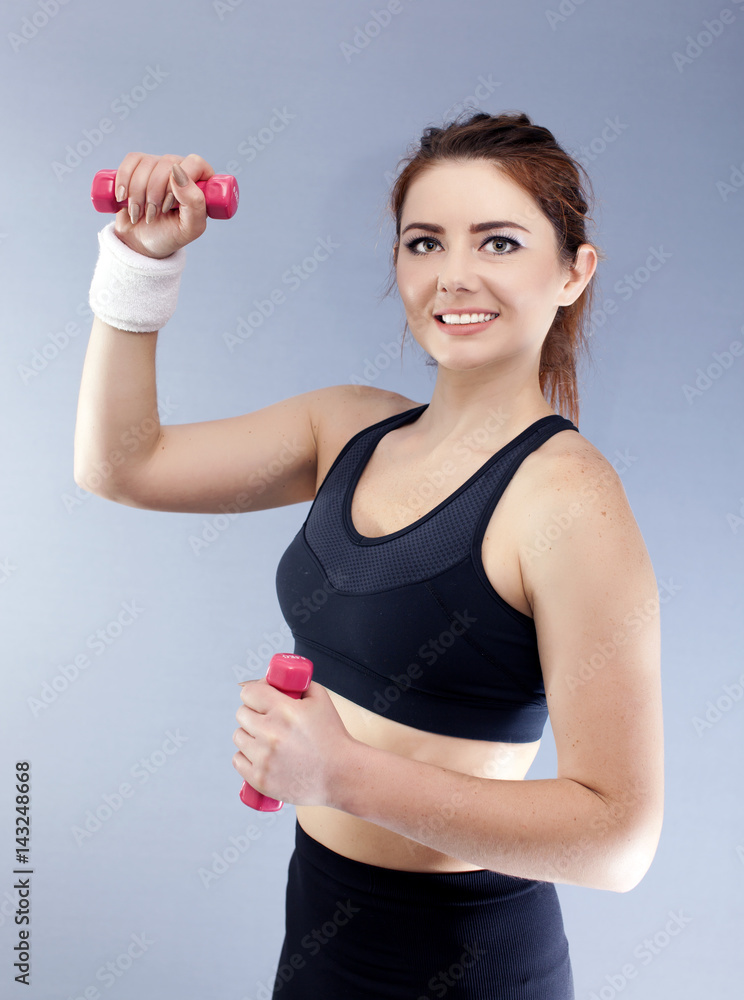 Sport woman with red dumbbells and towel smile, looking in camera.
Sport woman with red dumbbells and towel smile, looking in camera.