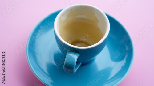 empty blue cup with rest of coffee