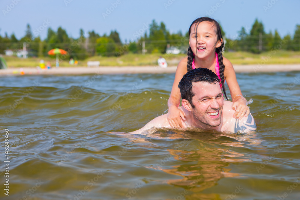 Mixed race father and daughter at the beach Mixed race father and daughter at the beach