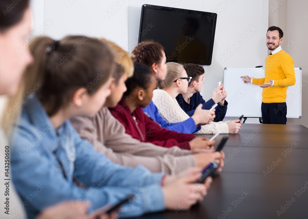 Fototapeta premium Pupils listening with interest teacher’s lecture