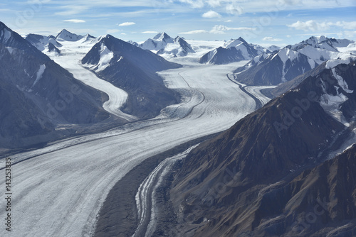 aerial photo of a glacier between mountains in alaska