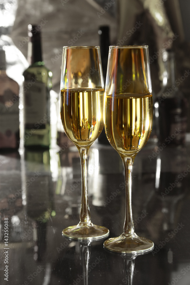 Glass of wine, brandy or cognac on the mirror wooden table