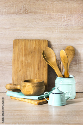 Turquoise and wooden vintage crockery, tableware, dishware utensils and stuff on wooden table-top. Kitchen still life as background for design. Image with copy space.