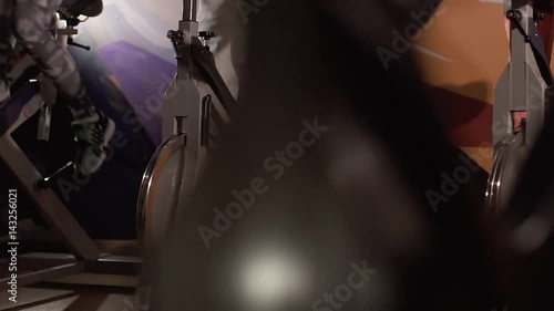 Close-up of people training their legs on stationary bikes