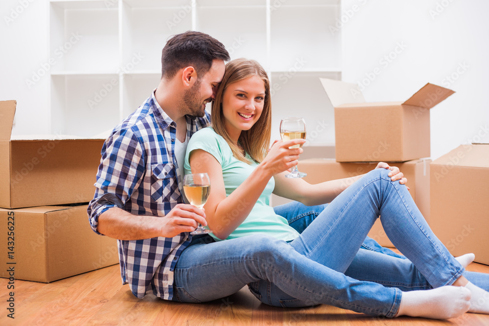 Young couple is moving in their new home. It's time for unpacking. Young couple is moving in their new home. It's time for unpacking.