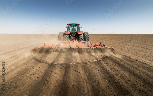 Tractor preparing land