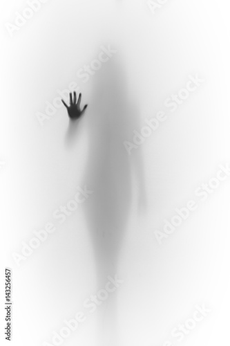 Silhouette of a hand and a blurred shape of woman