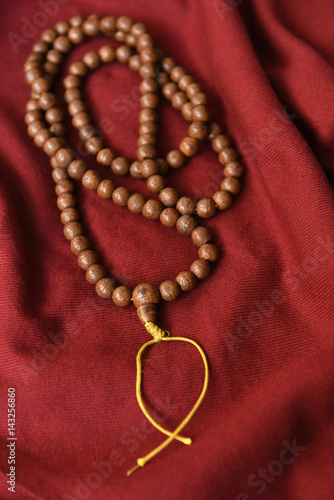 Buddhist prayer mala and red shawl photo