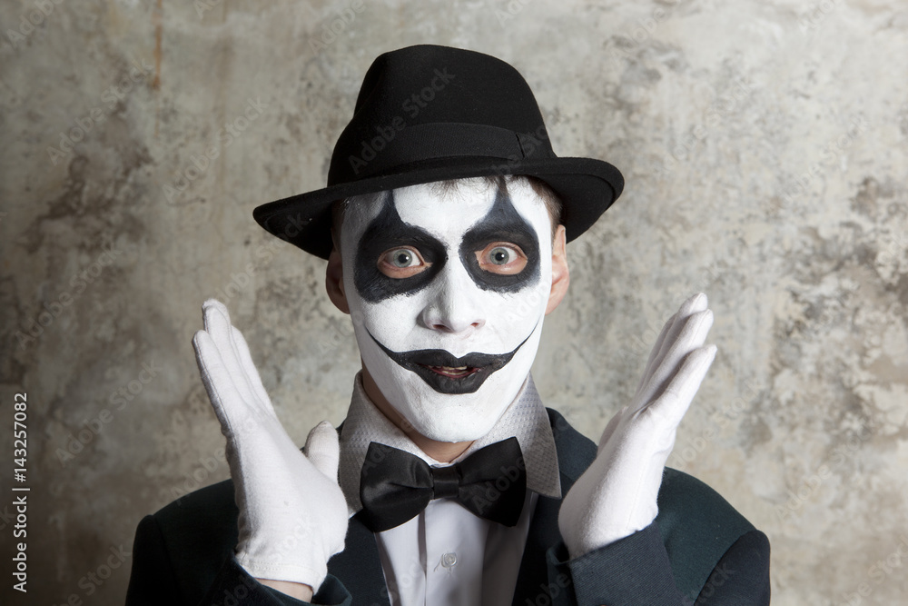 evil clown wearing a bowler hat wall background Stock-foto | Adobe Stock