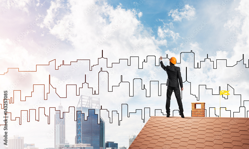 Man architect draw silhouette of modern city on blue sky. Mixed media Man architect draw silhouette of modern city on blue sky. Mixed media