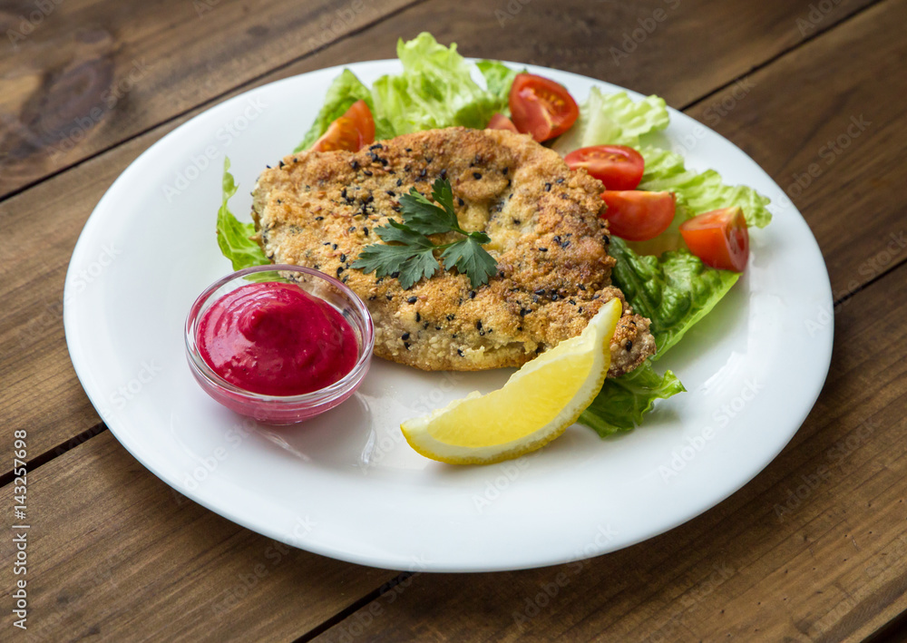 Homemade Breaded Schnitzel with salad and berry sauce Homemade Breaded Schnitzel with salad and berry sauce