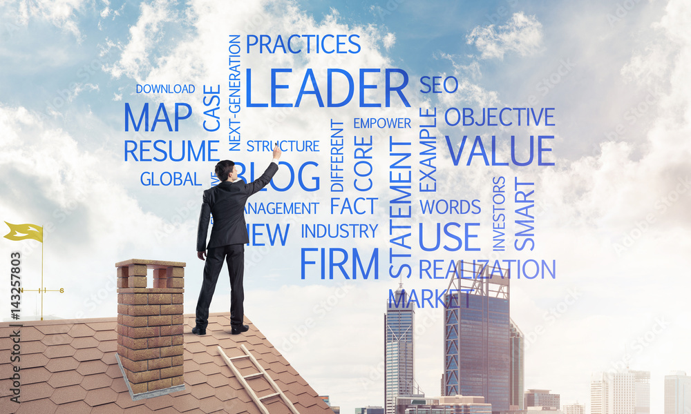 Young businessman standing on house roof and writing leadership Young businessman standing on house roof and writing leadership