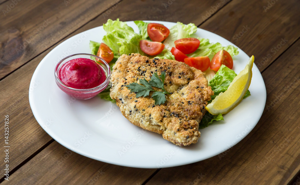 Homemade Breaded Schnitzel with salad and berry sauce Homemade Breaded Schnitzel with salad and berry sauce