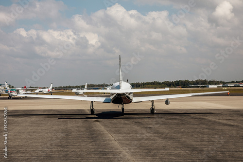Private small single piston aircraft on airport runway photo