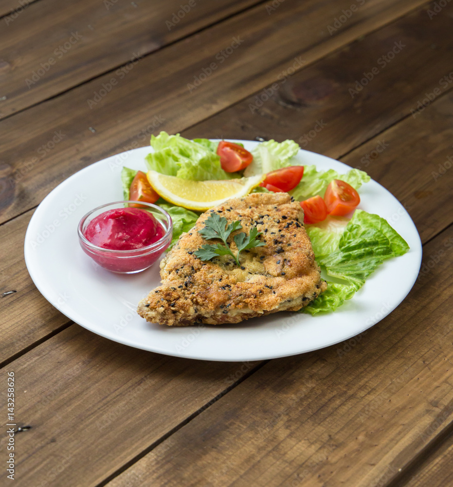 Homemade Breaded Schnitzel with salad and berry sauce Homemade Breaded Schnitzel with salad and berry sauce