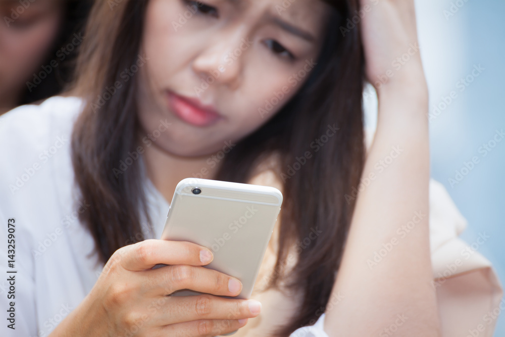 asian businesswoman using cell smart phone and confuse about bad news concept asian businesswoman using cell smart phone and confuse about bad news concept