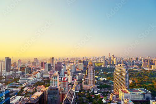 Sunset in megapolis. Beautiful cityscape with top view on skyscrapers. Bangkok, Thailand.