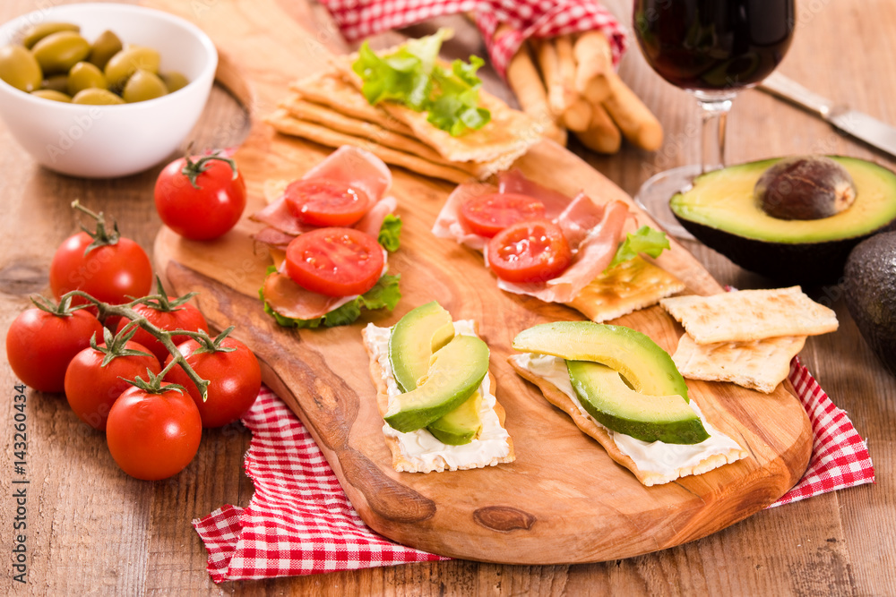 Crackers with ham and avocado. Crackers with ham and avocado.