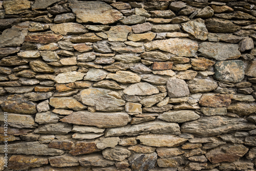 Dry masonry rock wall of natural stones with nice vignetting