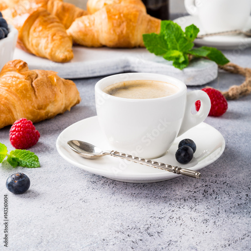 Healthy breakfast with coffee  croissants  fresh berries and orange juice on light gray background  selective focus  copy space.