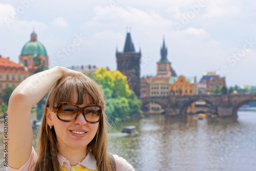 Young girl in sun glasses at Charles bridge in Prague