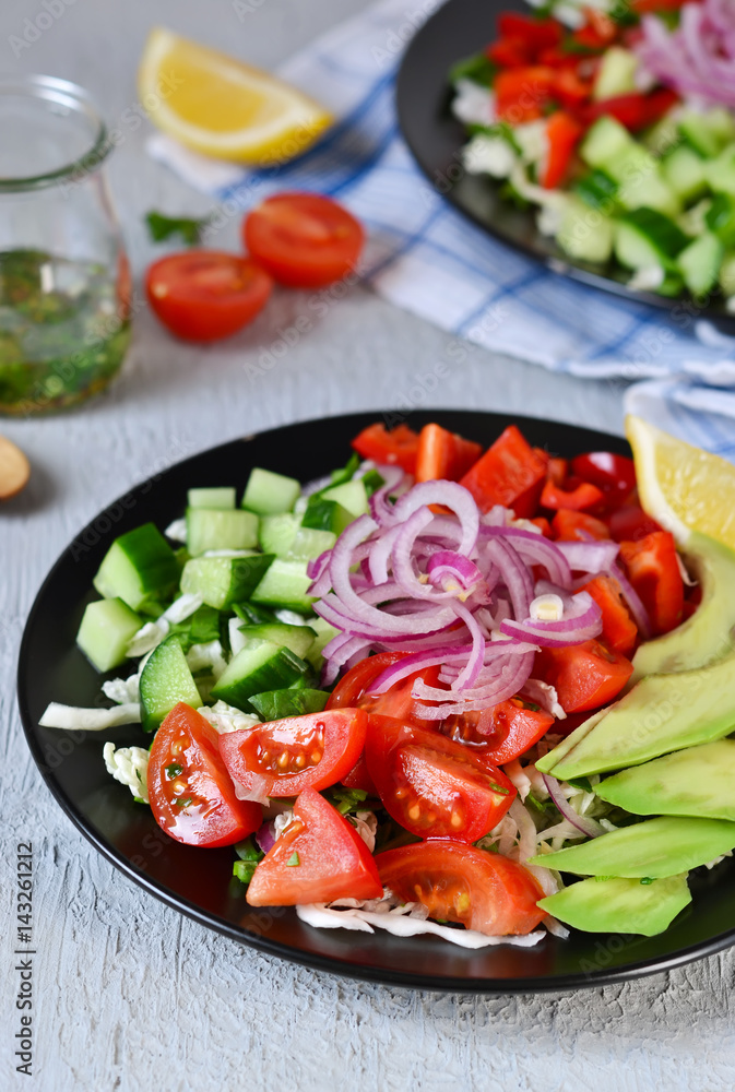 Vegetable salad with avocado and mustard sauce on a concrete, gray background Vegetable salad with avocado and mustard sauce on a concrete, gray background