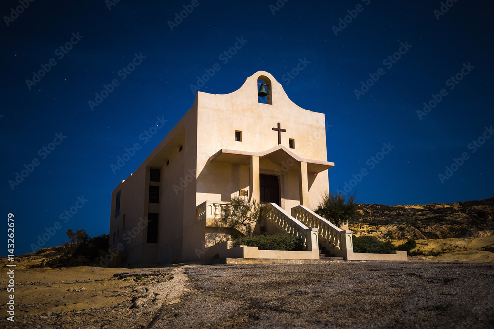 Gozo, Malta - The Saint Anne or Sant' Anna Chapel at Dwejra bay by night on the island of Gozo at full moon