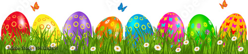 Easter eggs border with multicolored eggs in a grass with daisy and butterfly