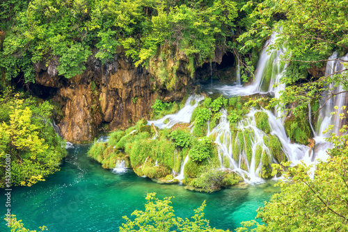 Plitvice Lakes National park, picturesque waterfall flows into the emerald la...