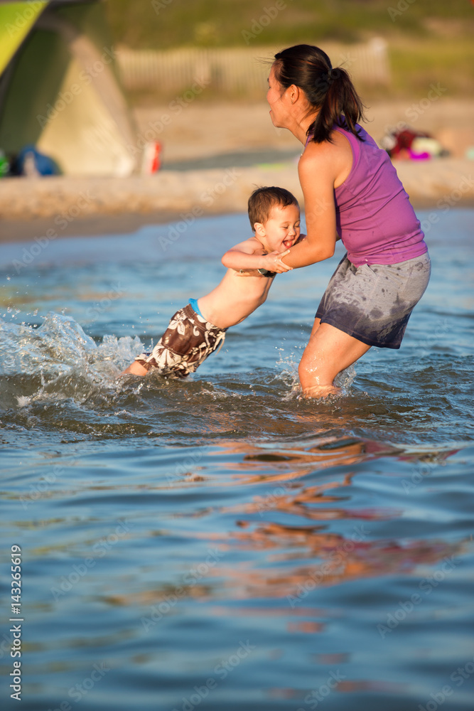 Fototapeta premium Daughter and son playing at the beach
