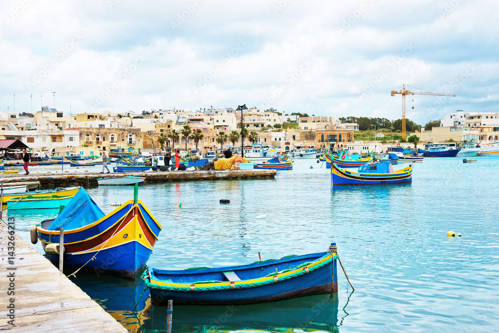 Luzzu colorful boats at Marsaxlokk Harbor at Malta