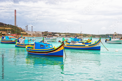 Luzzu colorful boats at Marsaxlokk Harbor of Malta