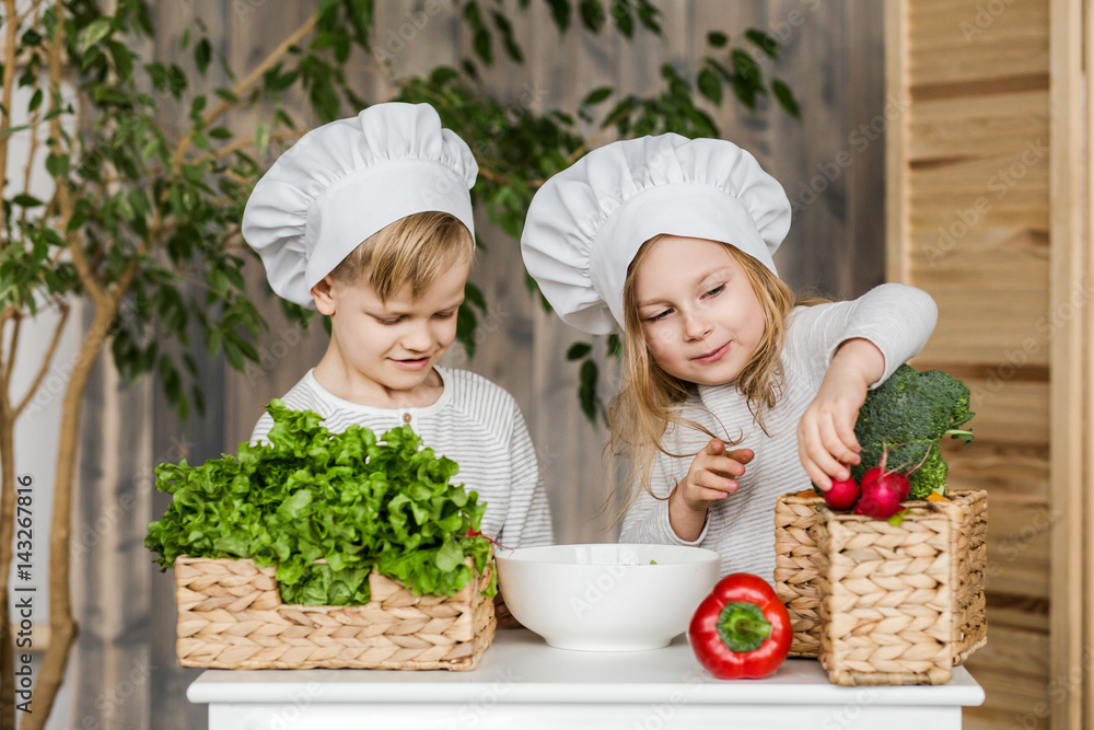 Kids in the kitchen making vegetable salads. Healthy food. Vegetables. Family Kids in the kitchen making vegetable salads. Healthy food. Vegetables. Family