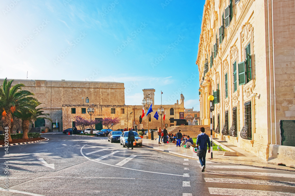 People at Auberge de Castille building in Merchant Street Valletta