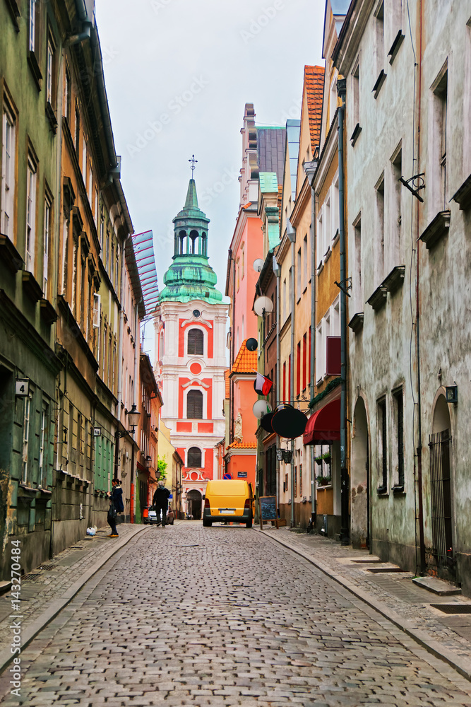 Cobblestone Street and St Stanislaus Church in Old town Poznan
