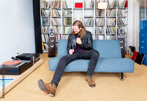 long haired man intensely ejoying rock music