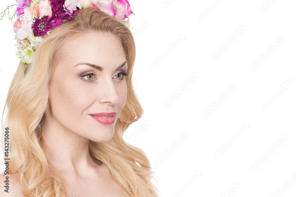 True queen. Shot of an astonishing beautiful mature woman wearing flower wreath looking away smiling warmly isolated on white