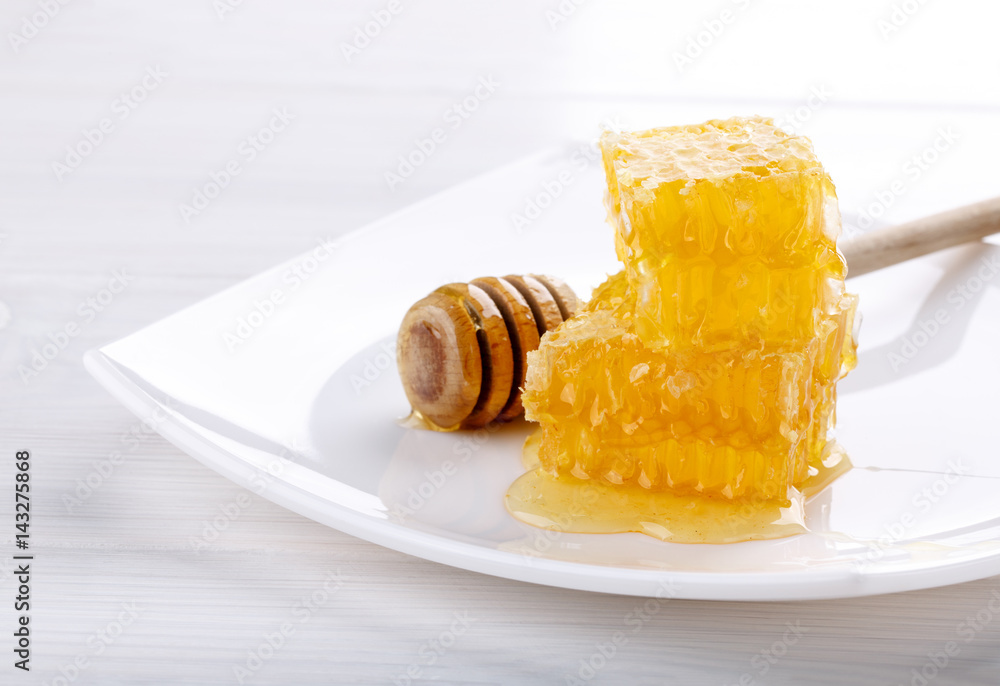 Stack of honeycombs with honey on white Stack of honeycombs with honey on white