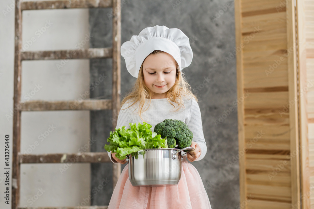 Little beautiful girl holding a pot full of vegetables. Healthy food. Harvest. Little housewife Little beautiful girl holding a pot full of vegetables. Healthy food. Harvest. Little housewife