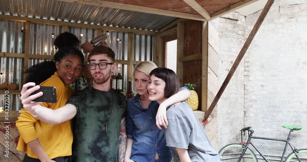 Group of friends at a street food bar taking selfie Group of friends at a street food bar taking selfie