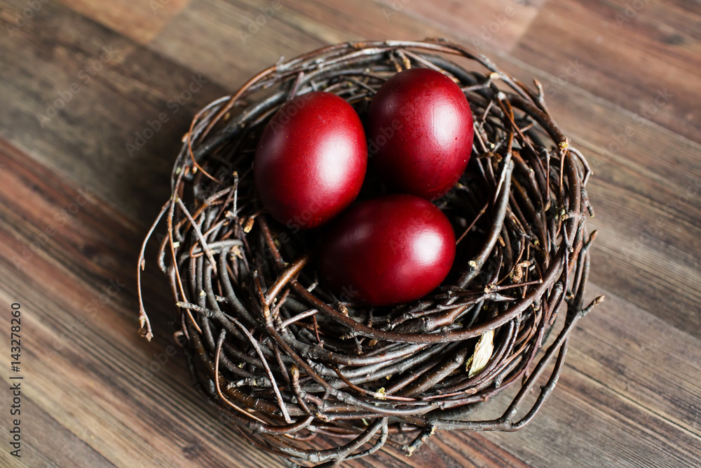 Easter eggs in the nest on wooden background Easter eggs in the nest on wooden background