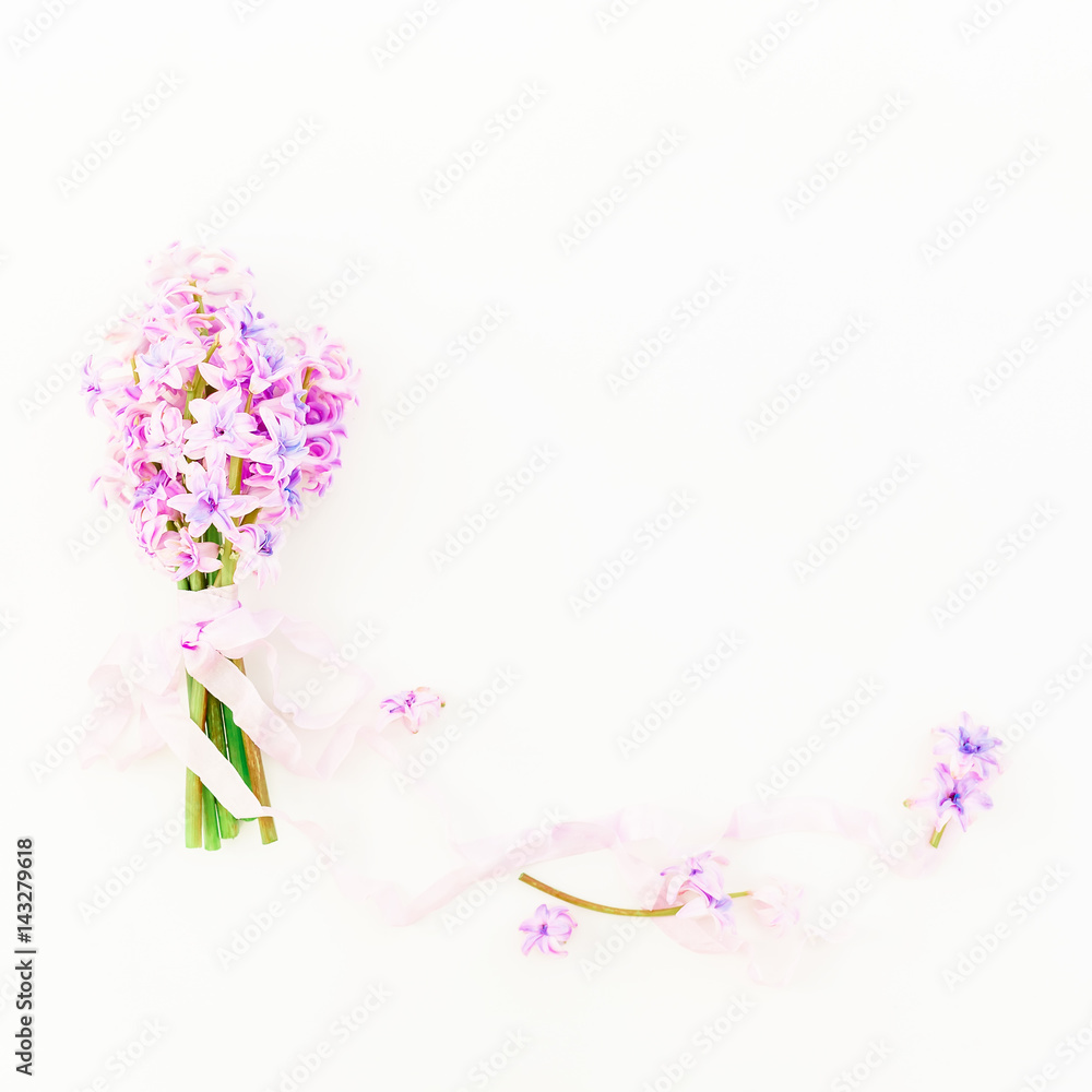 Bouquet of pink hyacinth flowers and tapes on white background. Flat lay, top view.