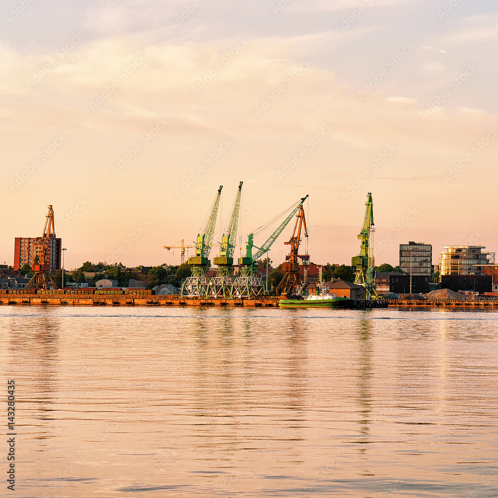 Loading cranes and oil tanks in Baltic sea in Klaipeda
