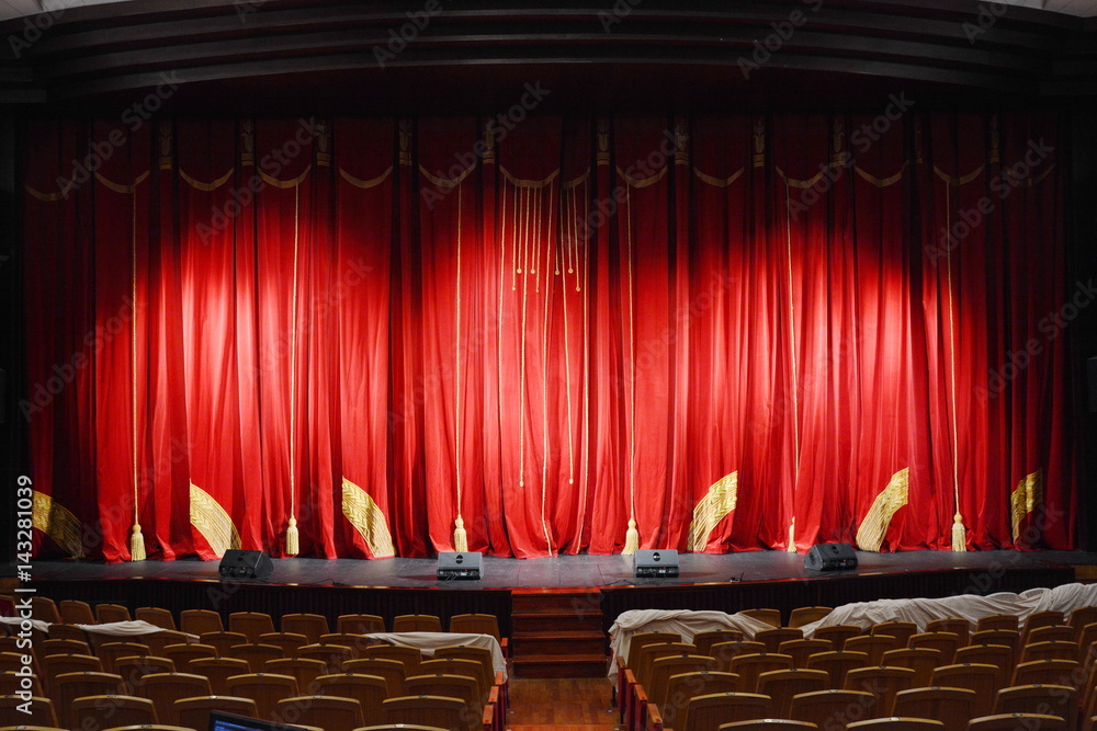 Obraz premium red theatre curtain with gold tassels and embroidery. the stage