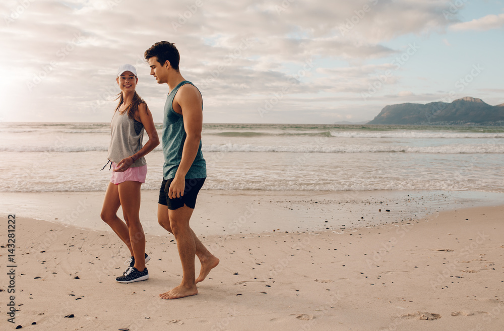 Young couple on walking along the shore Young couple on walking along the shore