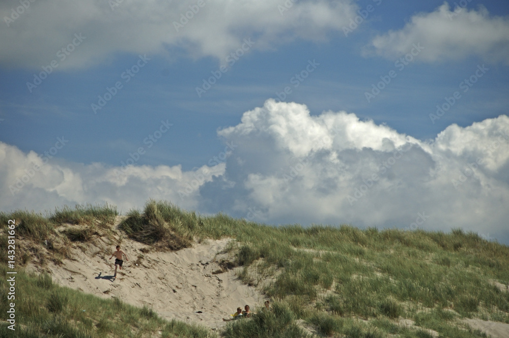 Schoorl, The Netherlands, 28, juni, 2006: Boy running down from dunes beach Holland