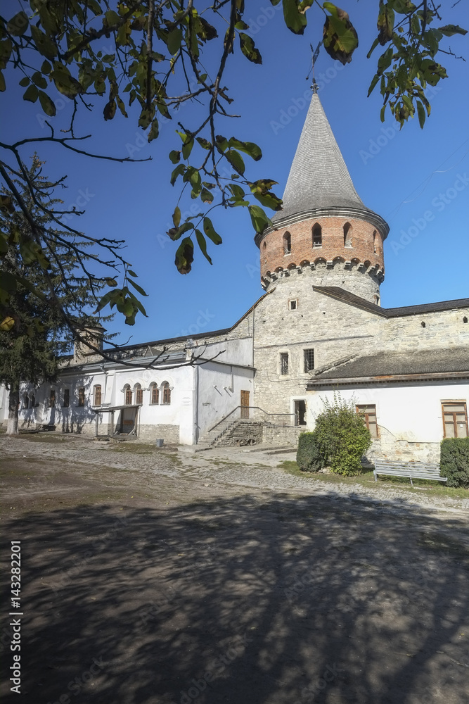 Inner courtyard and tower of Kamianets-Podilskyi castle in Western Ukraine. Shot on a beautiful clear autumn day with blue skies.