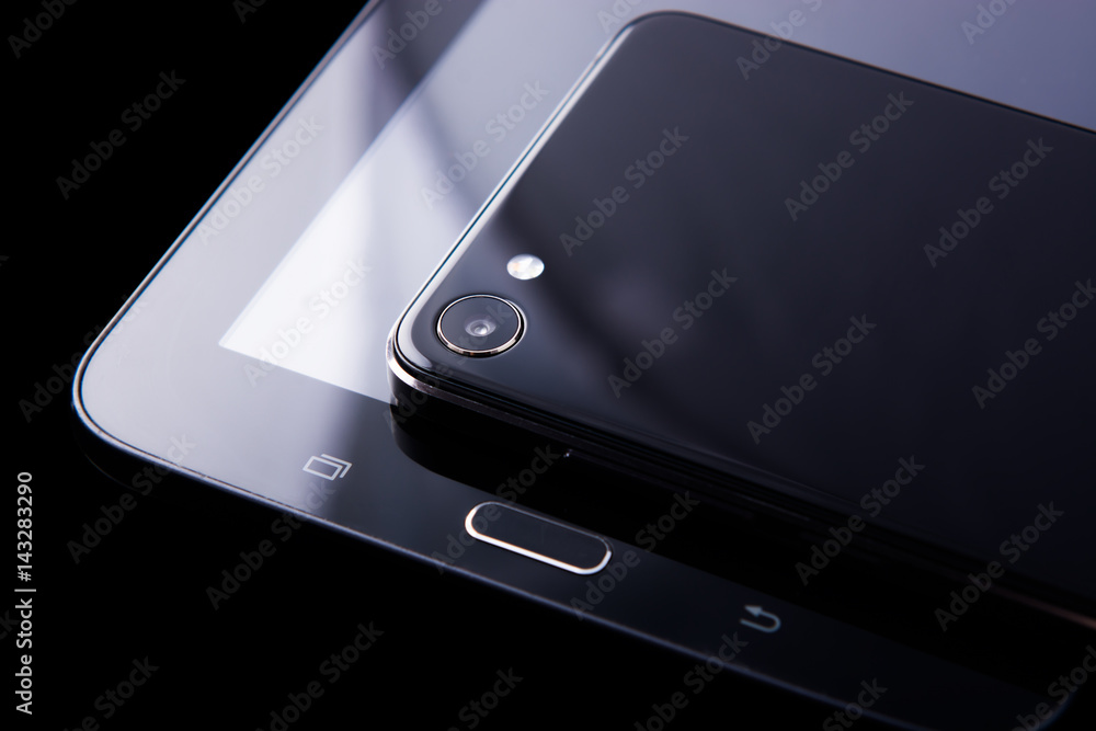 tablet and smartphone on black background tablet and smartphone on black background