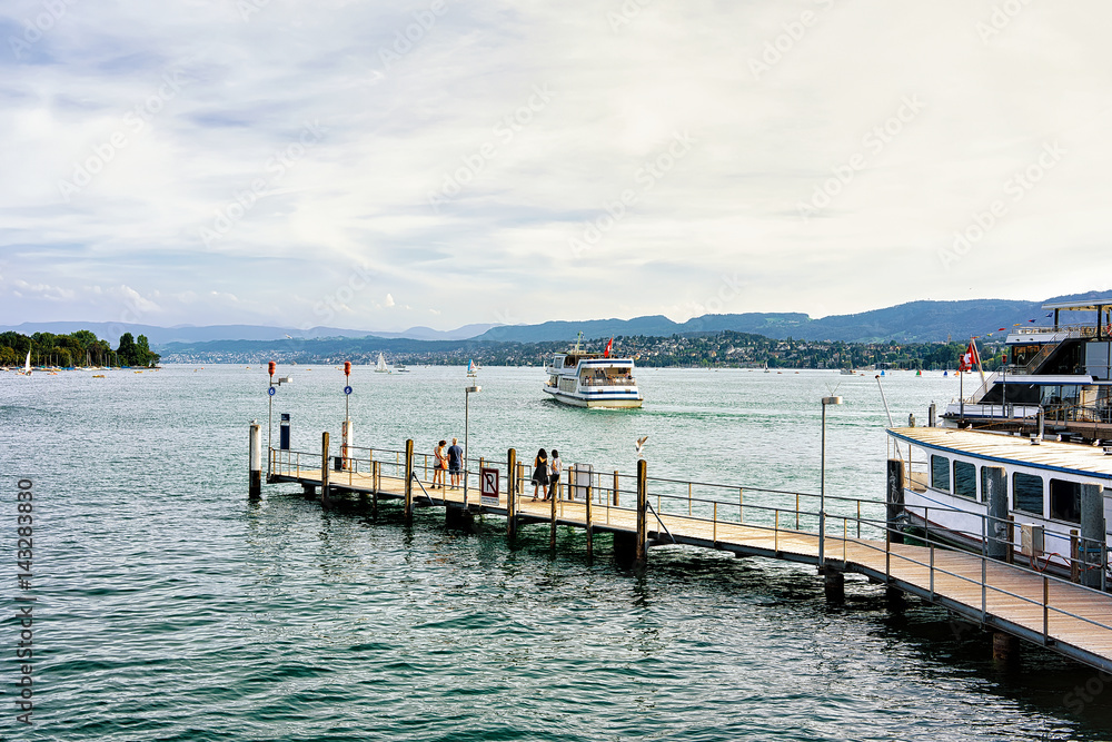 People at Pier with ferry in Zurich Lake