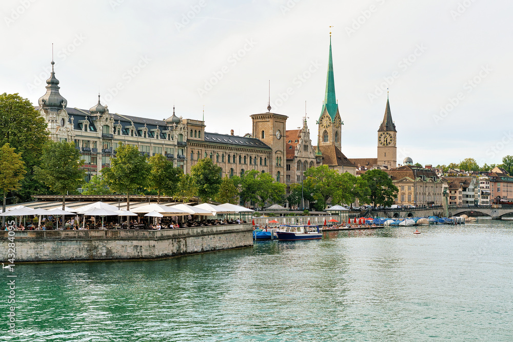 Restaurant terrace at Limmat quay and Saint Peter and Fraumunster